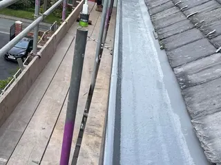 Long lead gutter installed along the edge of a roof