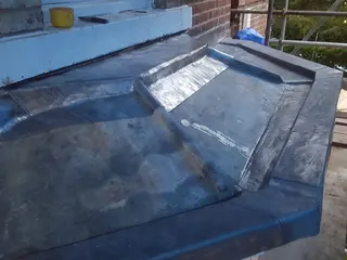 Welded lead detailing around a complex roof junction